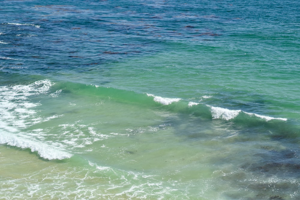 a man riding a surfboard on top of a wave in the ocean