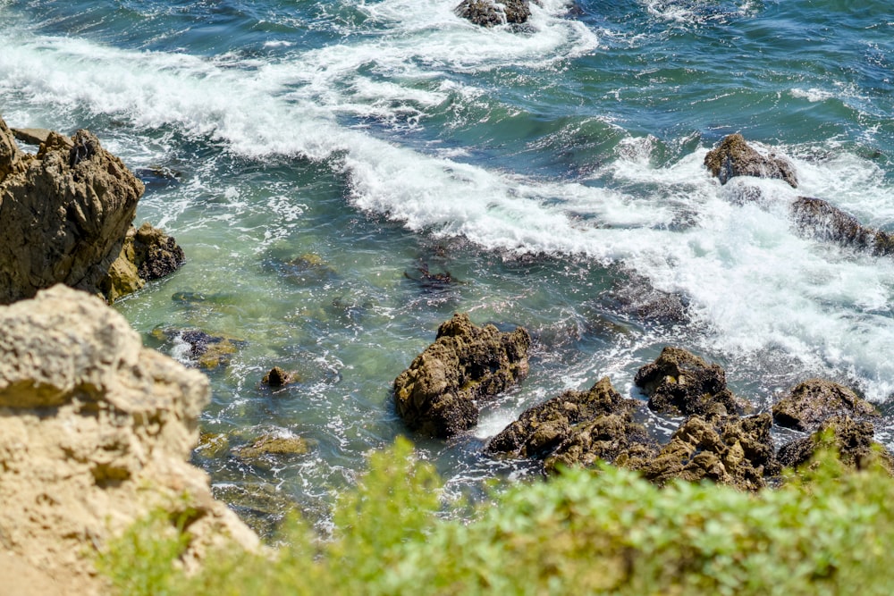 a view of a body of water with rocks in the foreground