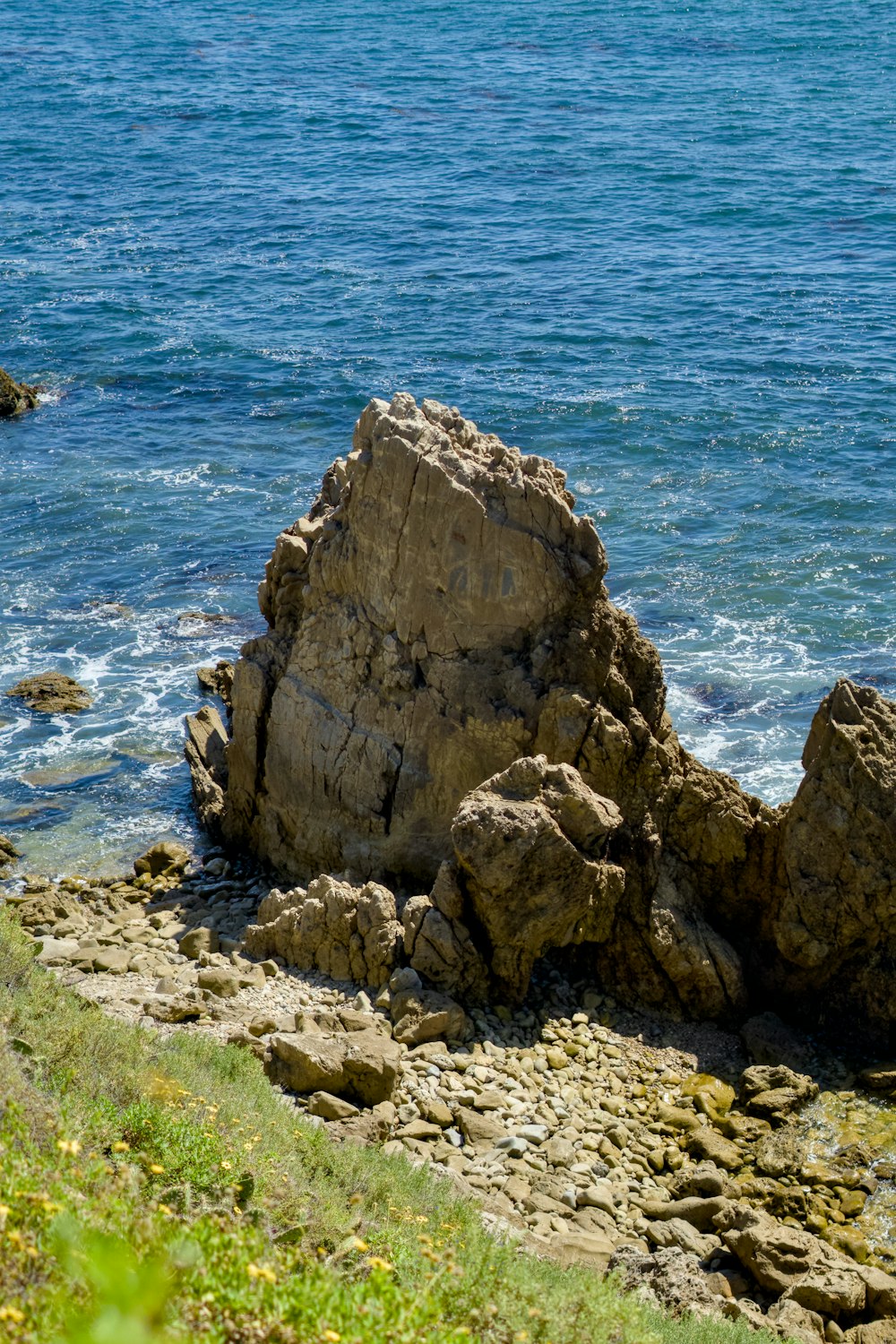 a large rock outcropping next to a body of water