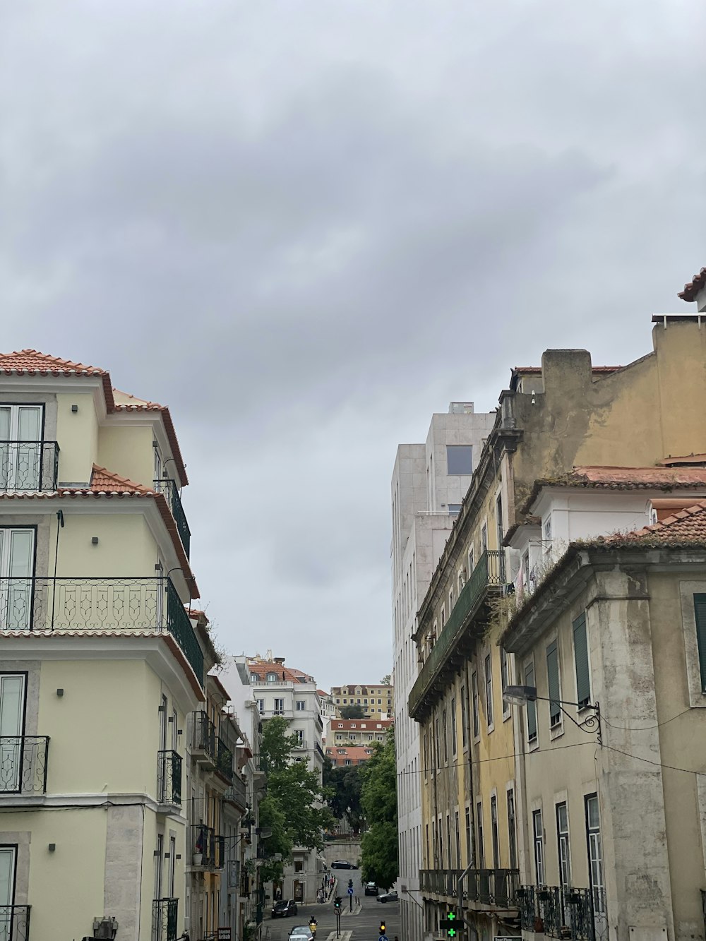 a city street with cars and buildings on both sides