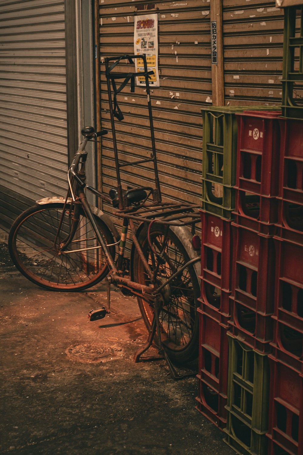 a bicycle parked next to a pile of crates