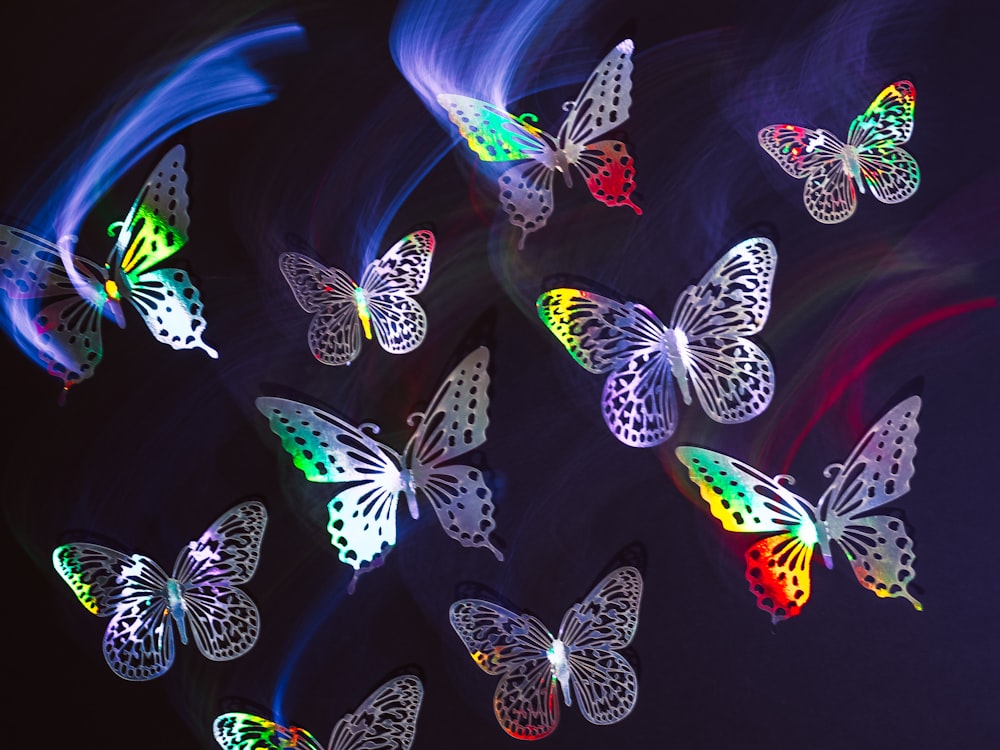 a group of colorful butterflies flying through the air