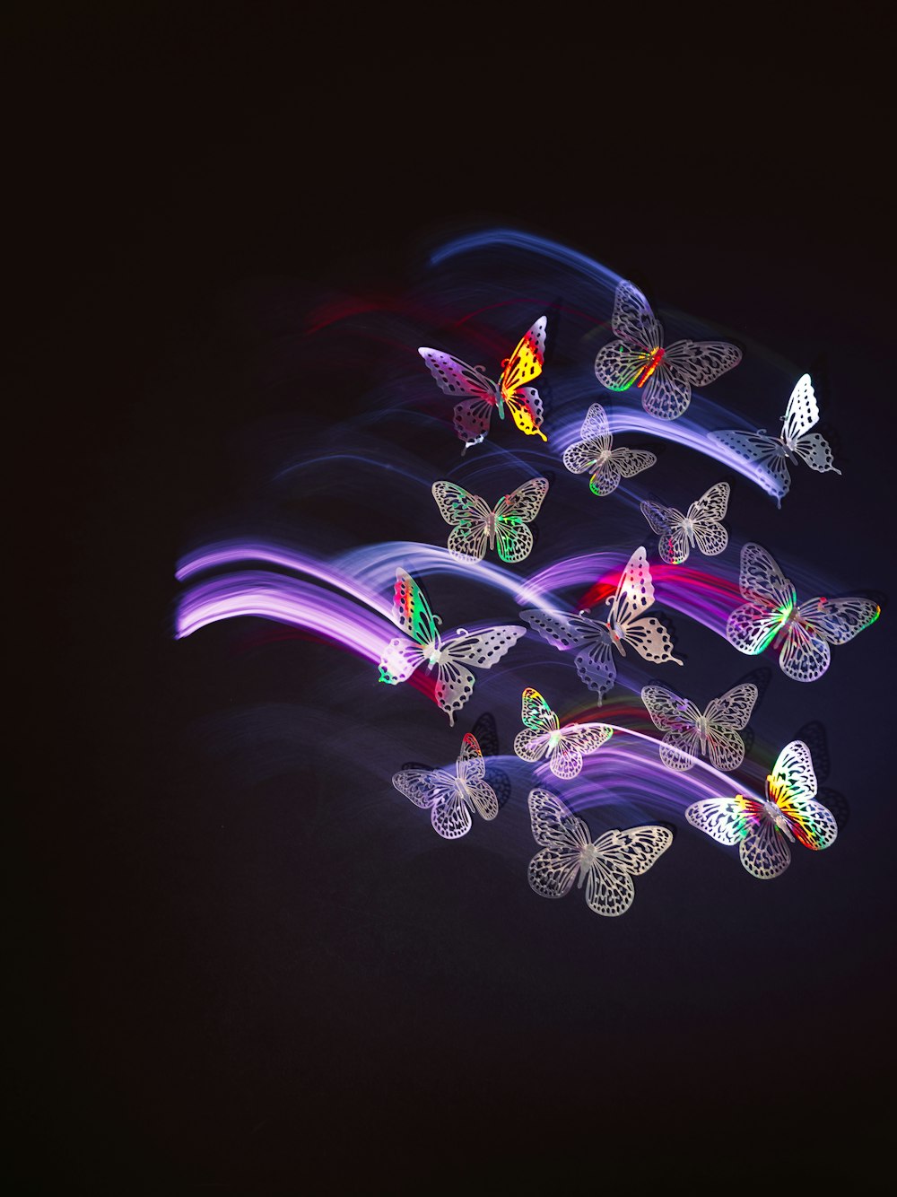 a group of butterflies flying through the air