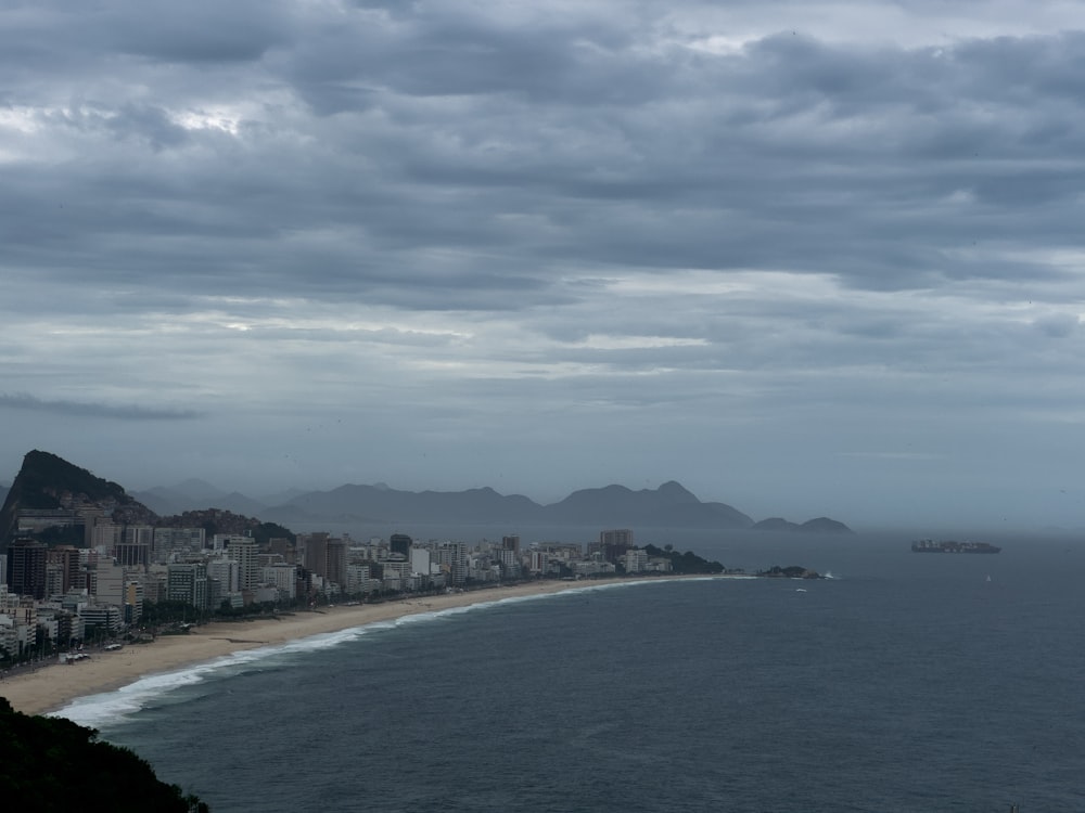 a view of a beach with a city in the distance