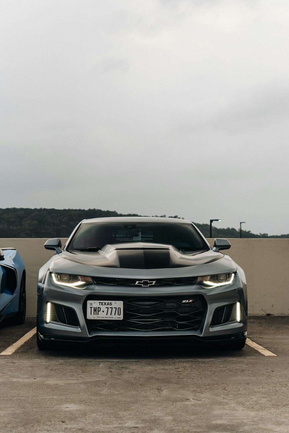 two cars parked in a parking lot next to each other