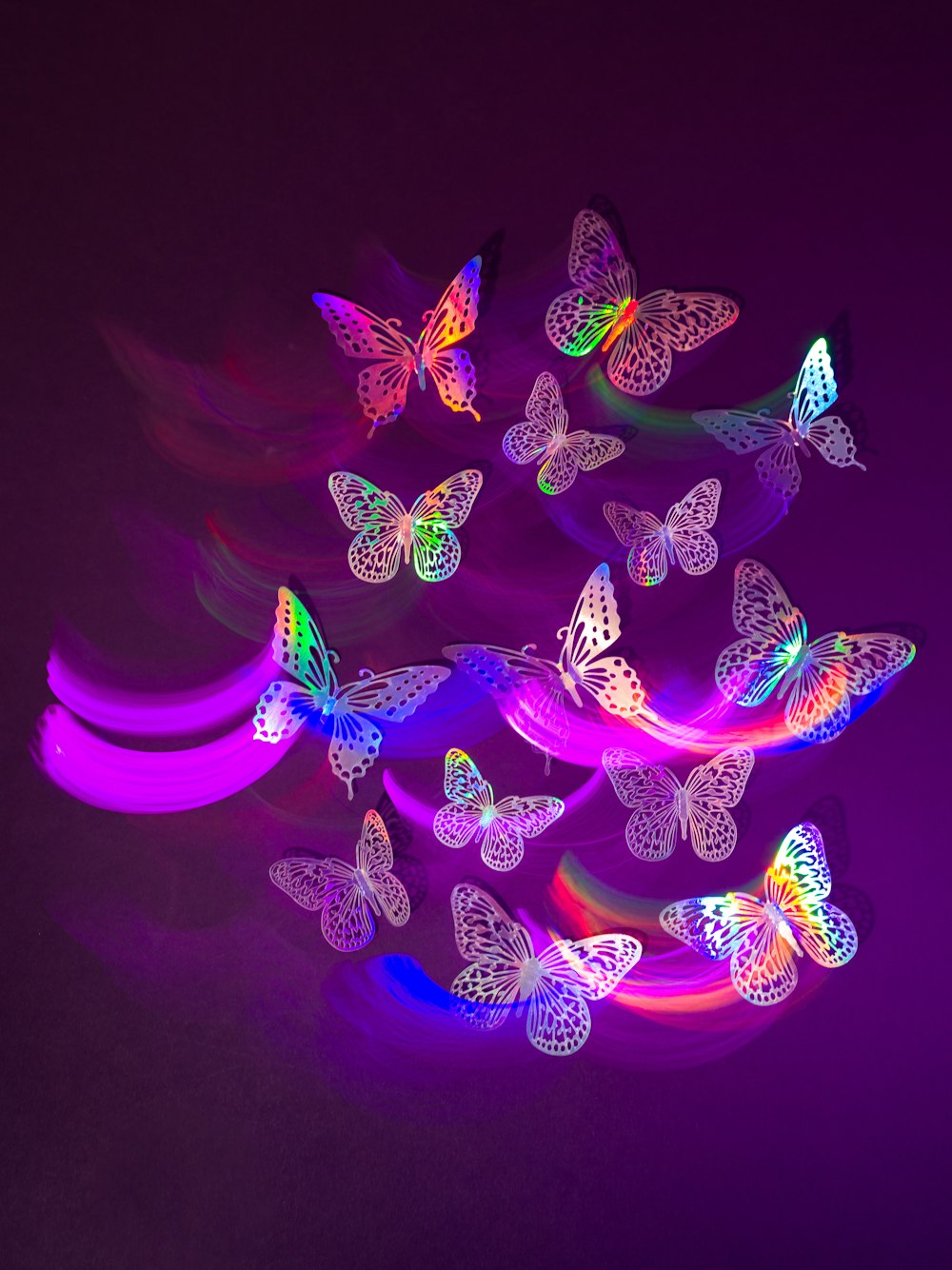 a bunch of butterflies that are glowing in the dark