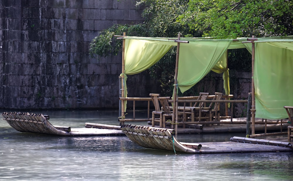 a couple of small boats floating on top of a river