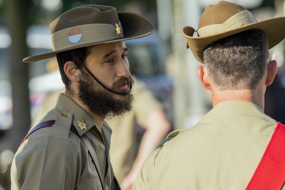 a man in a uniform talking to another man