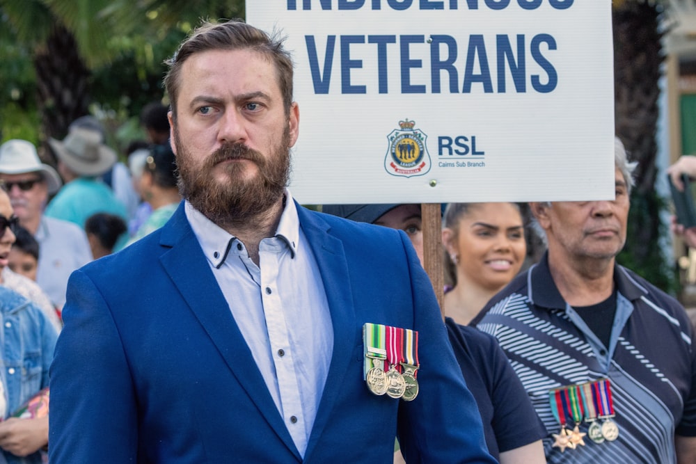 a man in a blue suit holding a sign