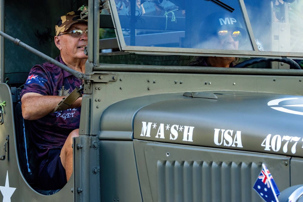 a man sitting in the driver's seat of a truck