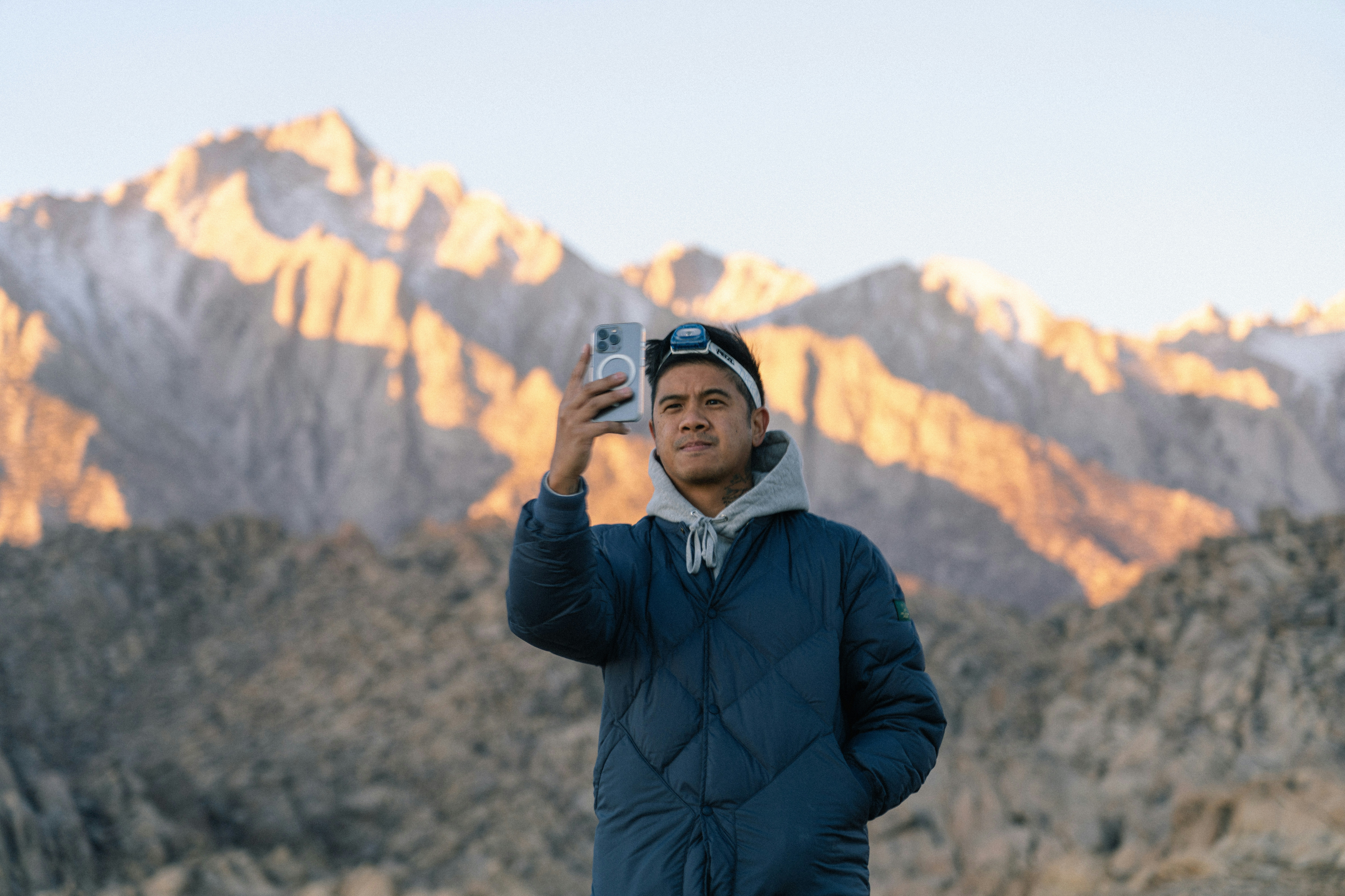 a man taking a picture of a mountain range