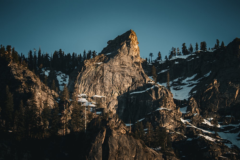 a very tall mountain with a lot of trees on top of it