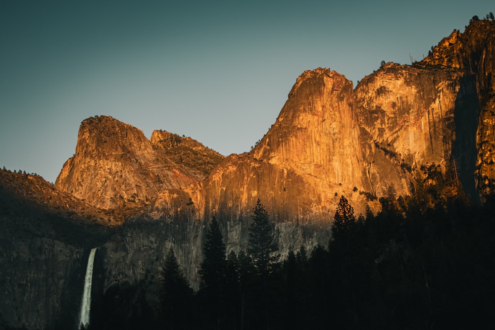 a mountain with a waterfall in the middle of it