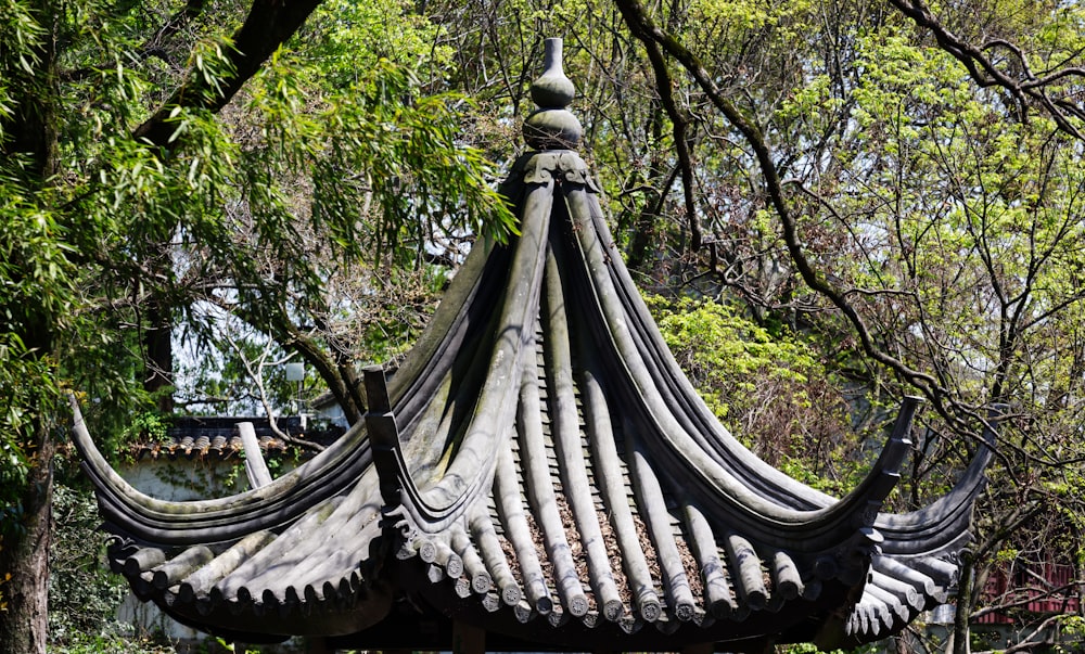 a gazebo in the middle of a park surrounded by trees