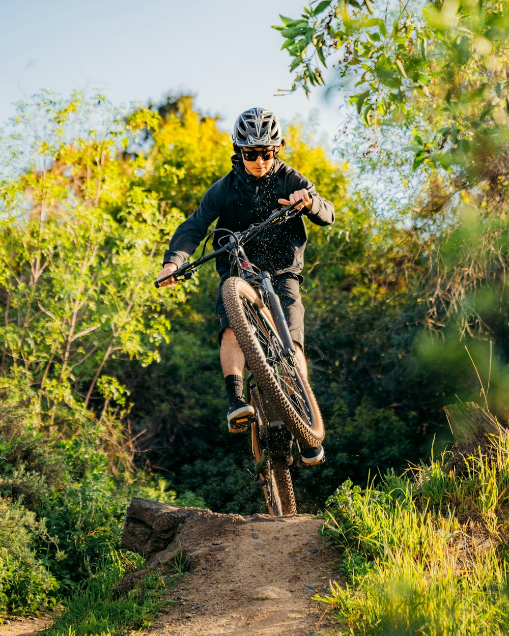 a man riding a bike down a dirt trail