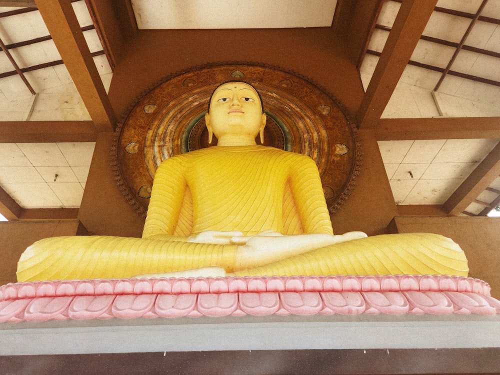 a statue of a person sitting in a meditation position