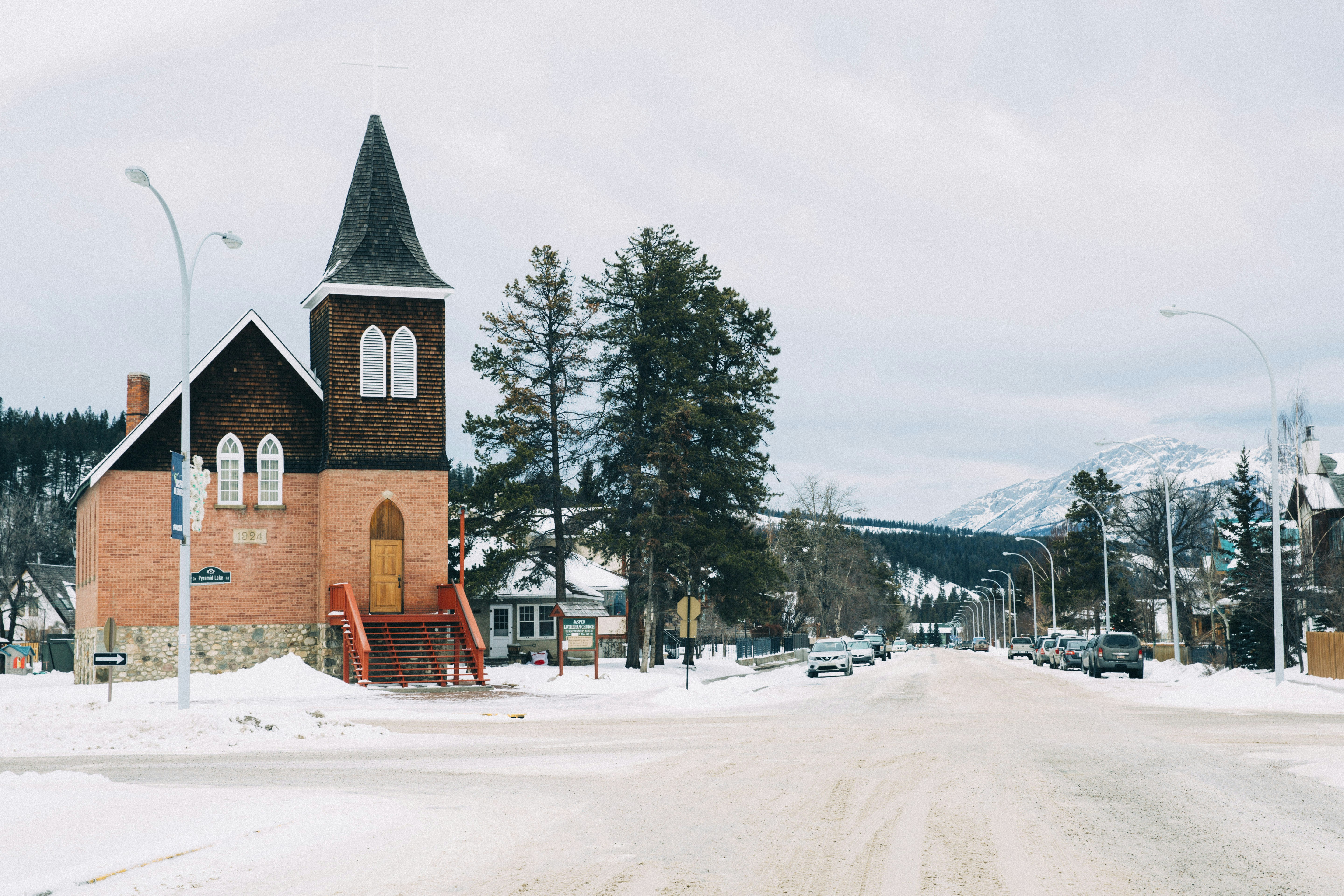a church in the middle of a snowy street