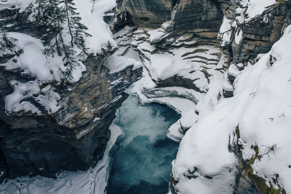 an aerial view of a frozen river in a canyon