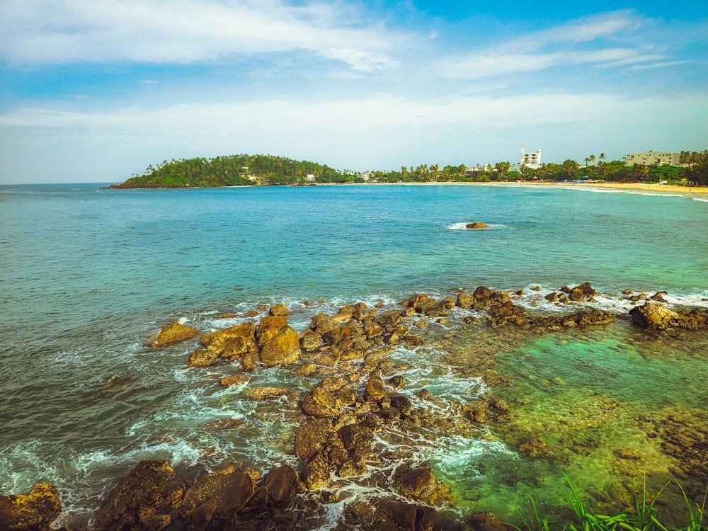 a view of the ocean with a small island in the distance