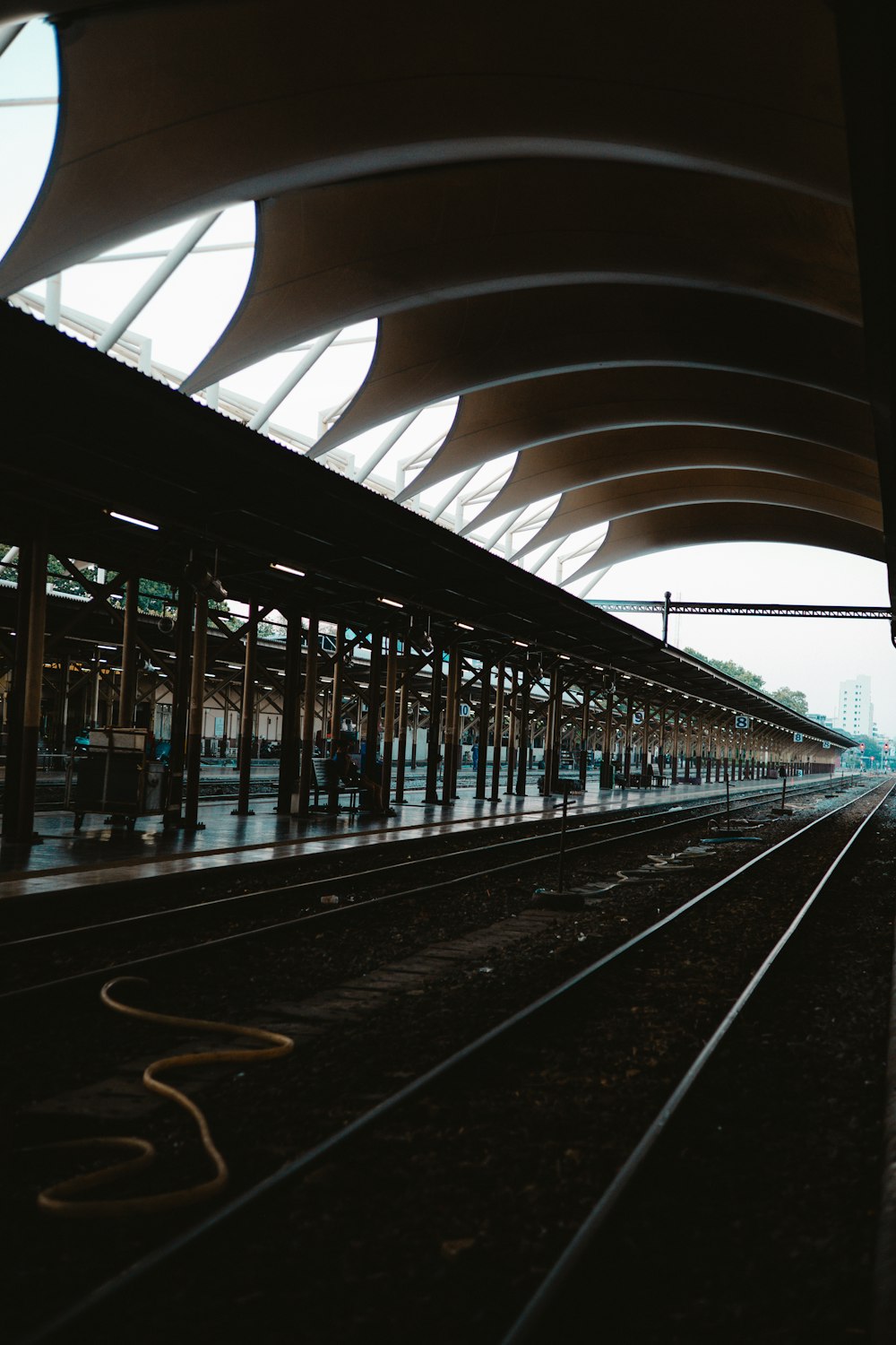 a train station with a train on the tracks