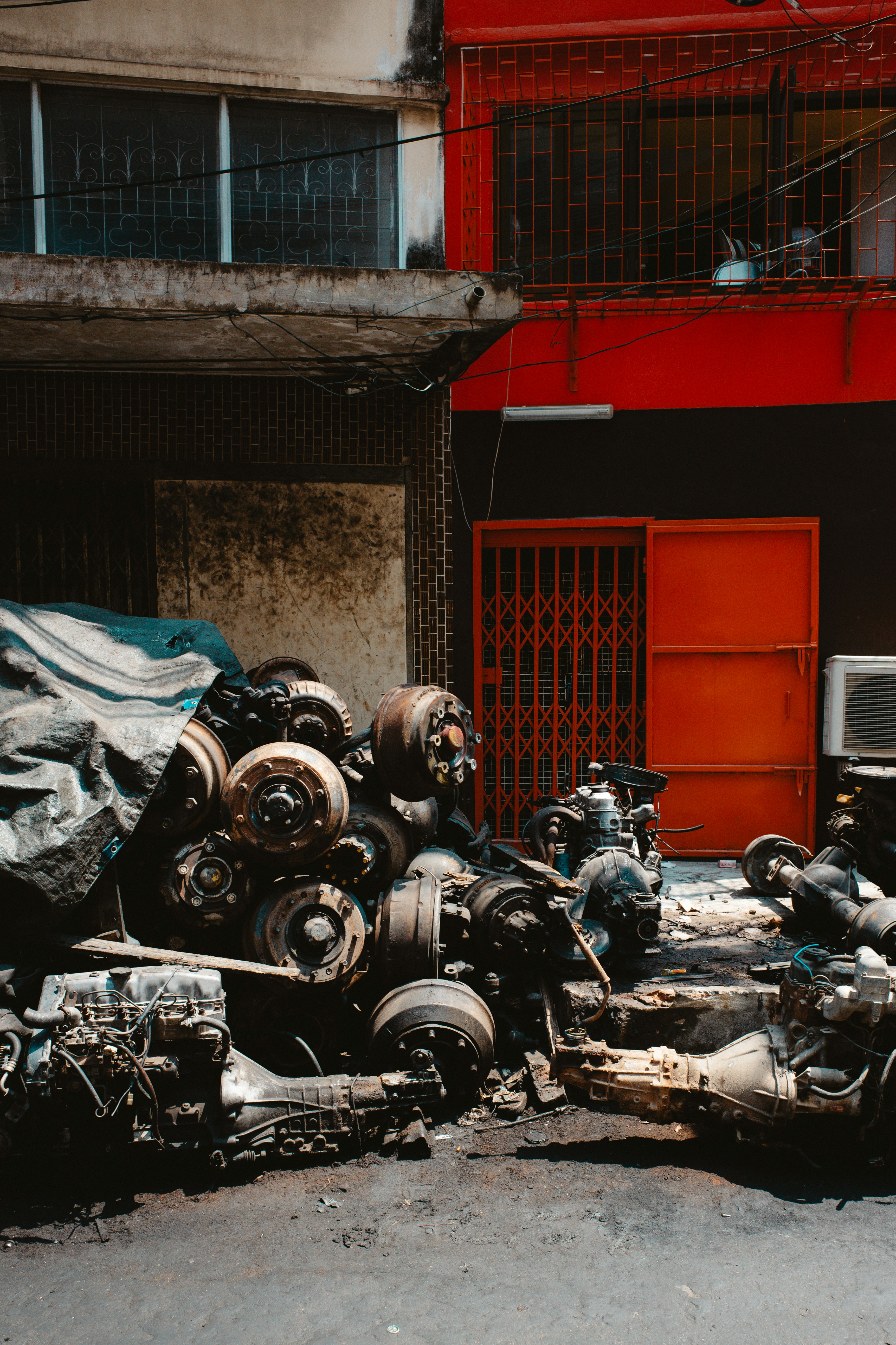 a pile of junk sitting in front of a red building
