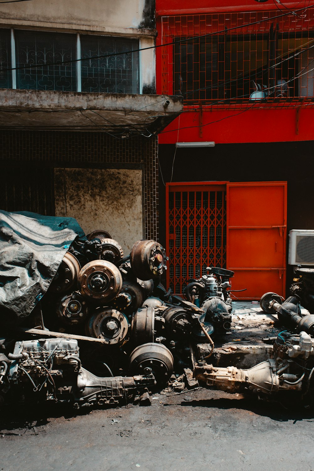 a pile of junk sitting in front of a red building