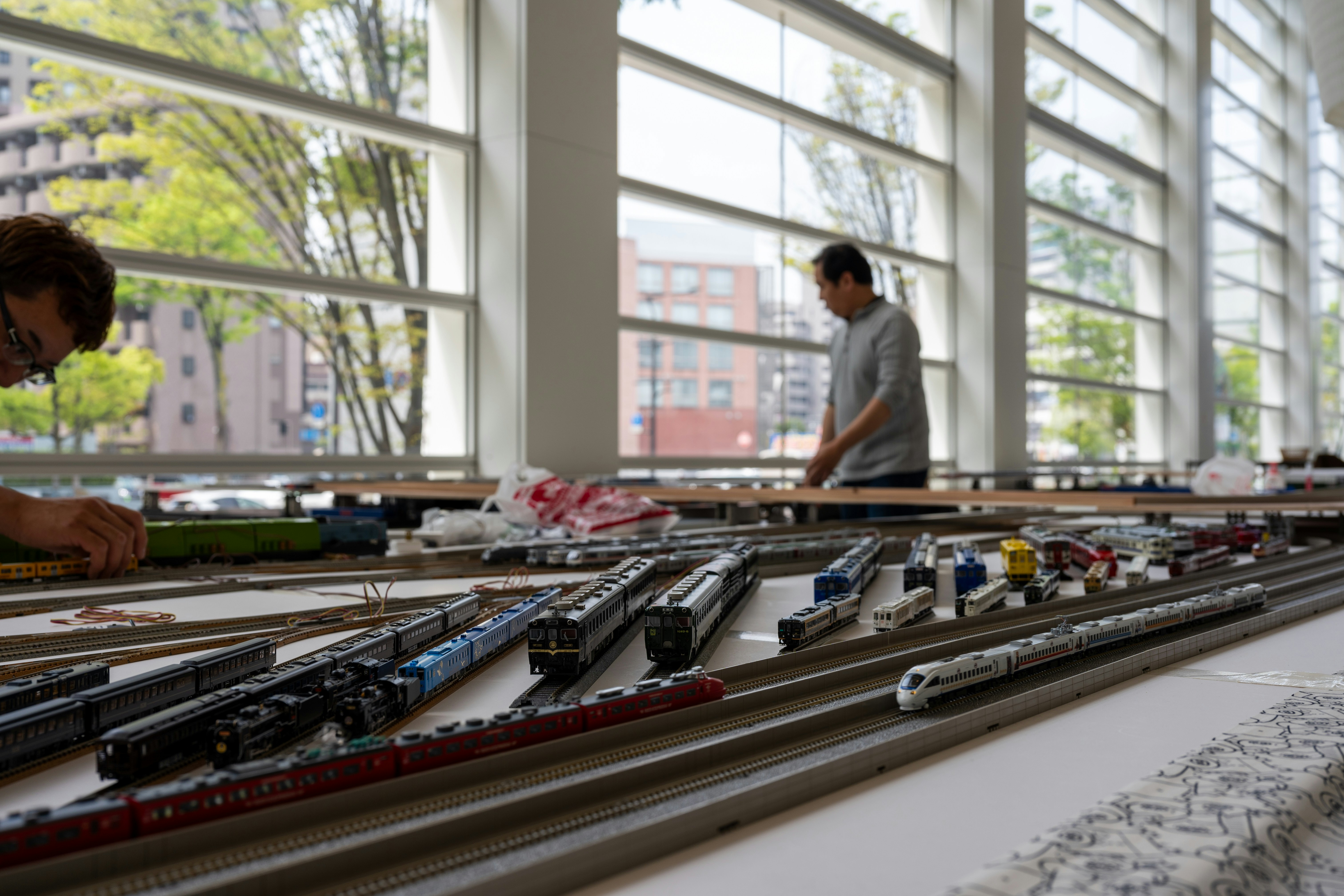 two men working on a model train set