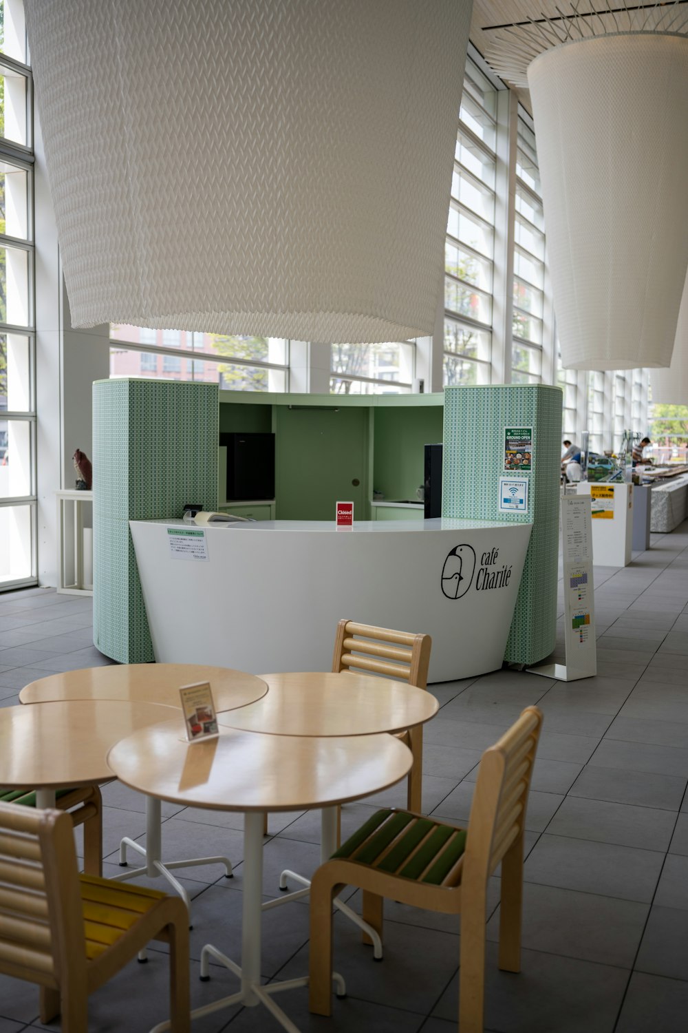 a table and chairs in a room with large windows