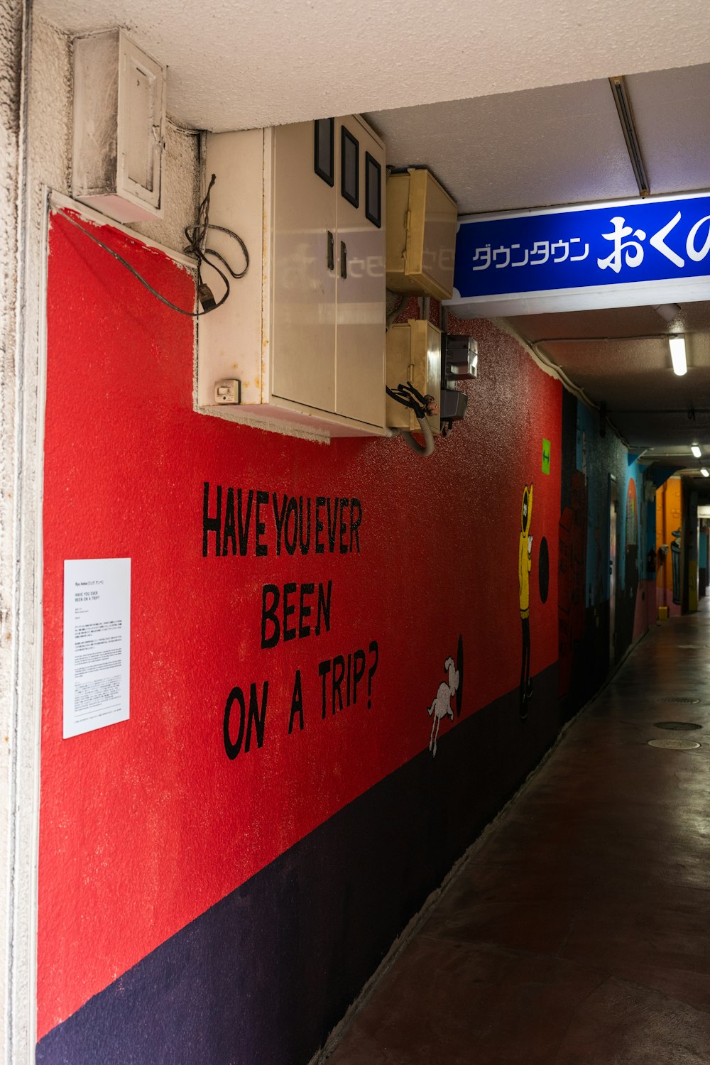 a red wall with a sign that says have you ever been on a trip?