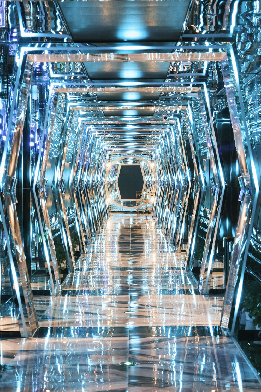 a very long hallway with a lot of mirrors on it