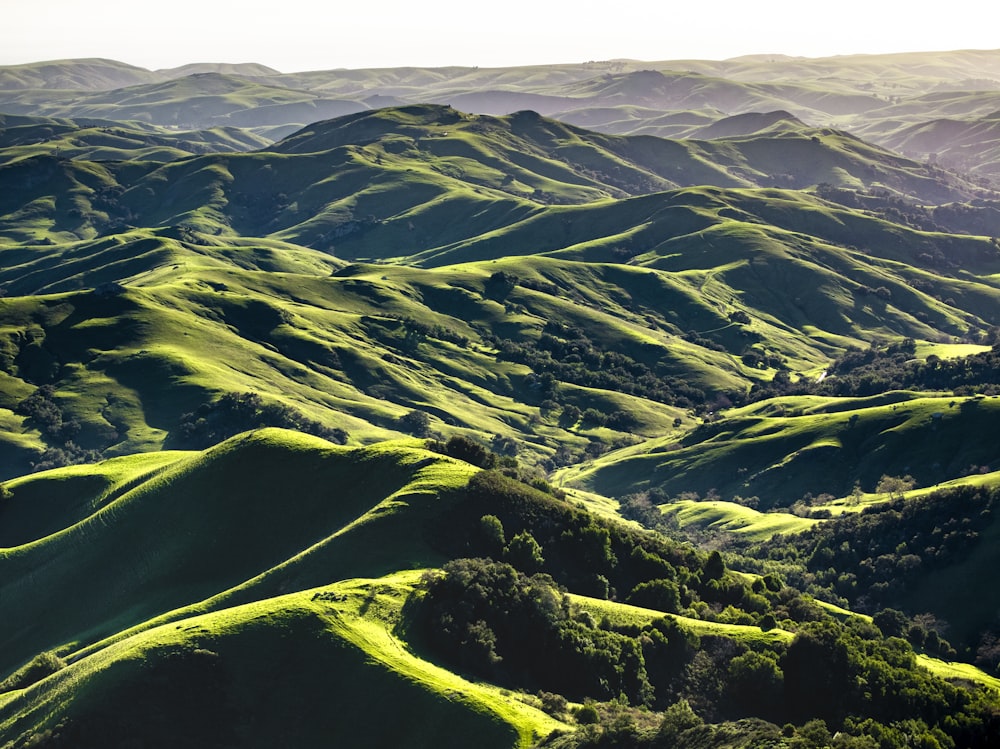 a scenic view of a green mountain range