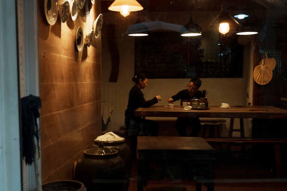 two people sitting at a table in a restaurant