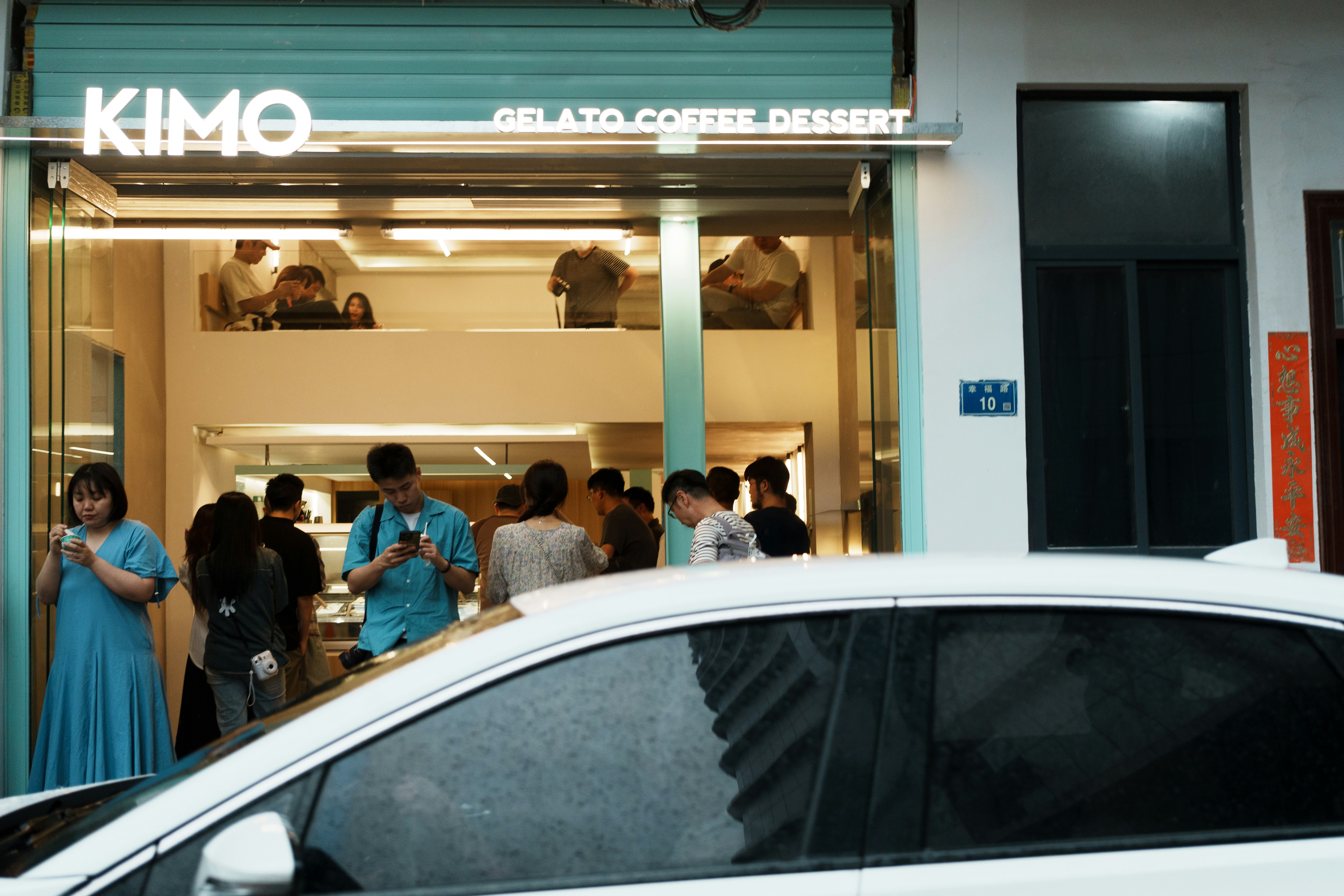 Customer discussing a used electric vehicle purchase with a salesperson at a dealership