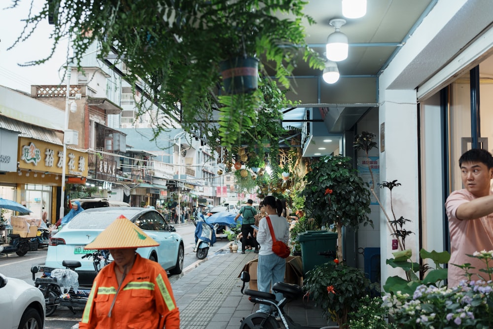 a man in an orange jacket is walking down the street