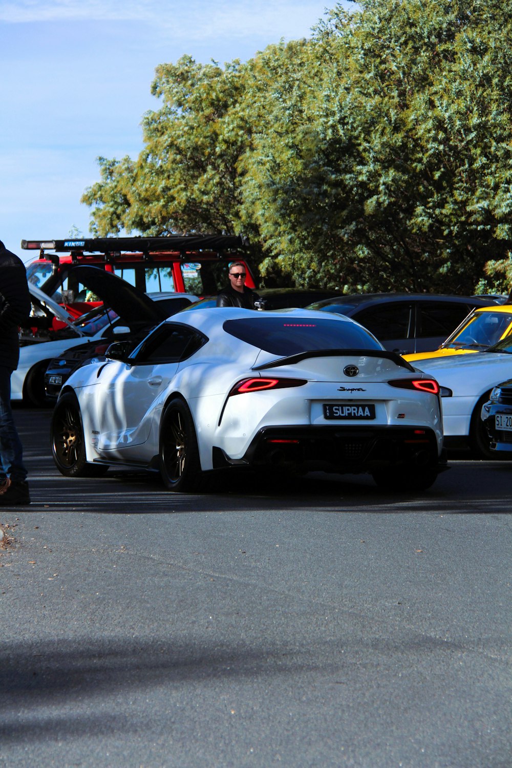 a white sports car parked in a parking lot