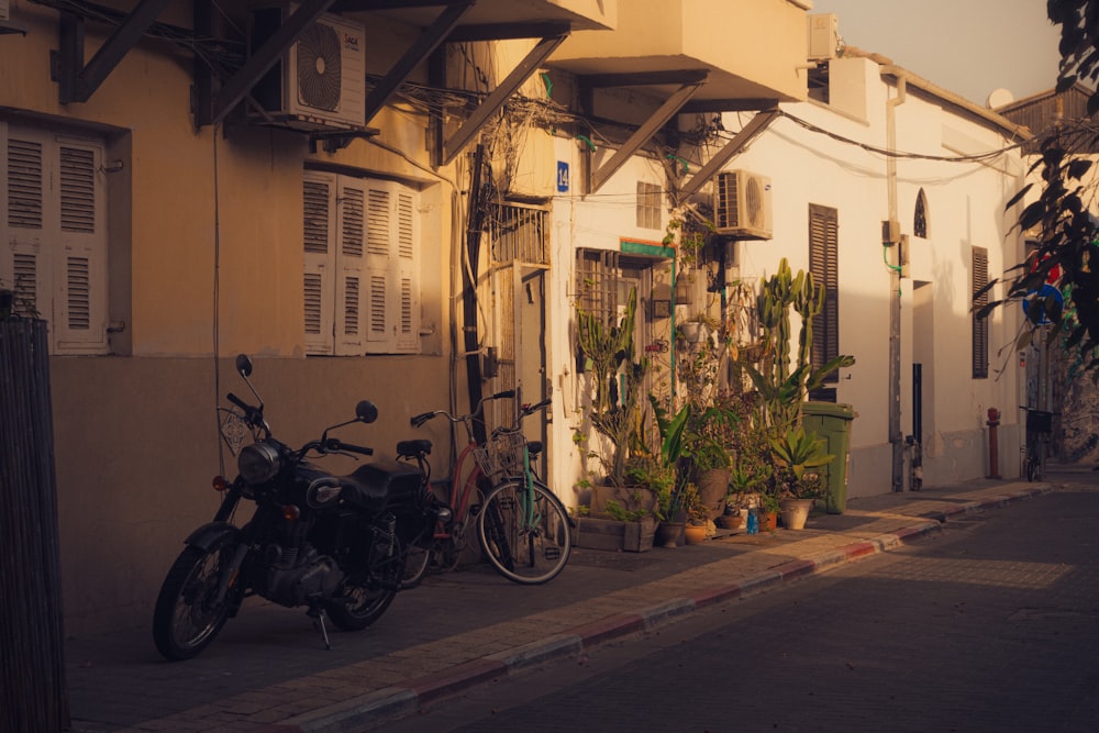 a motorcycle parked on the side of a street next to a building