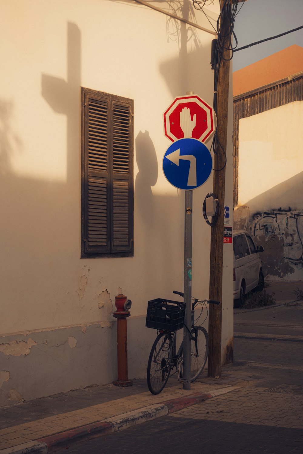 a bicycle parked next to a stop sign