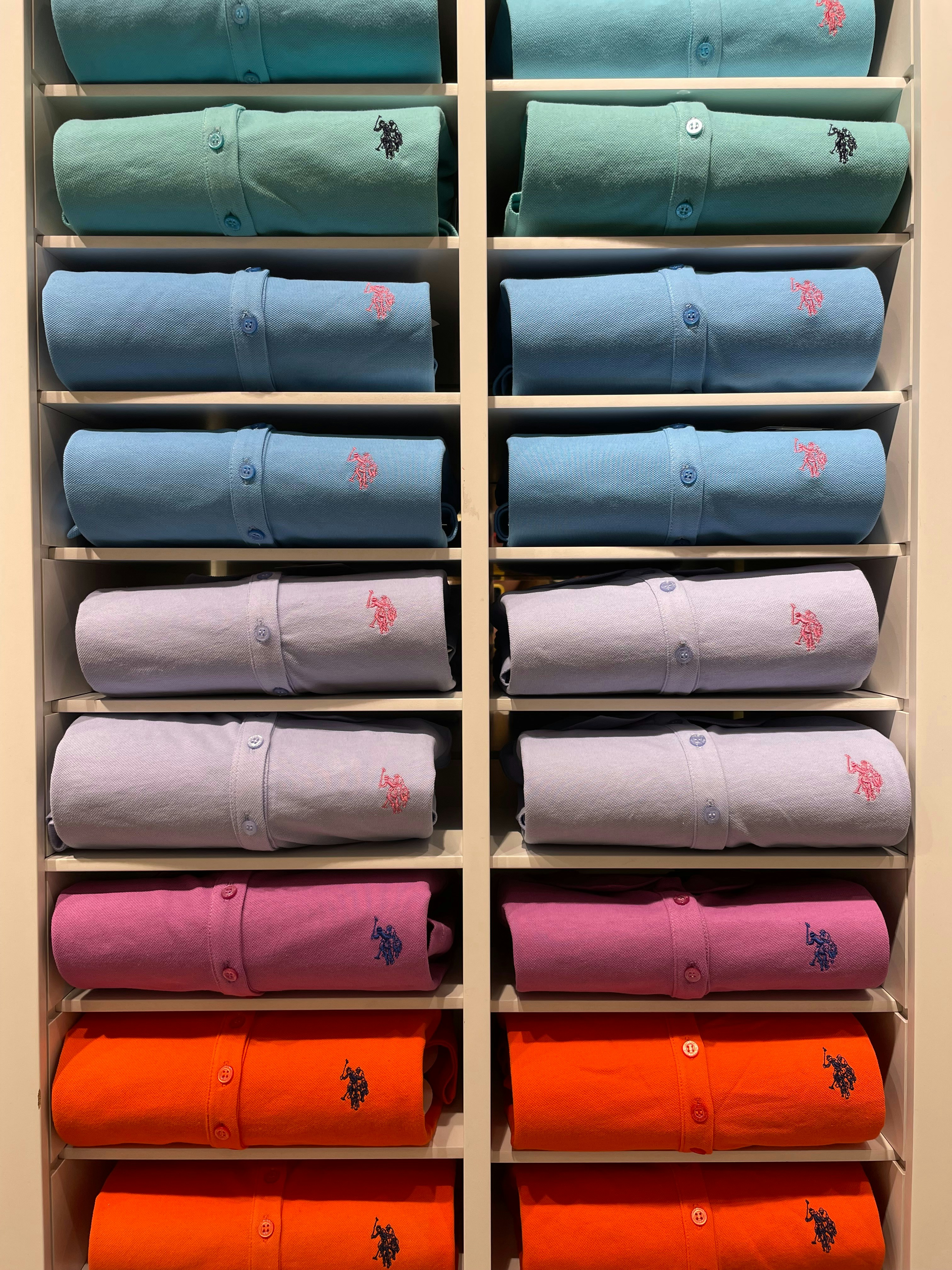 University branded t-shirts and hoodies arranged in a bright clean retail display