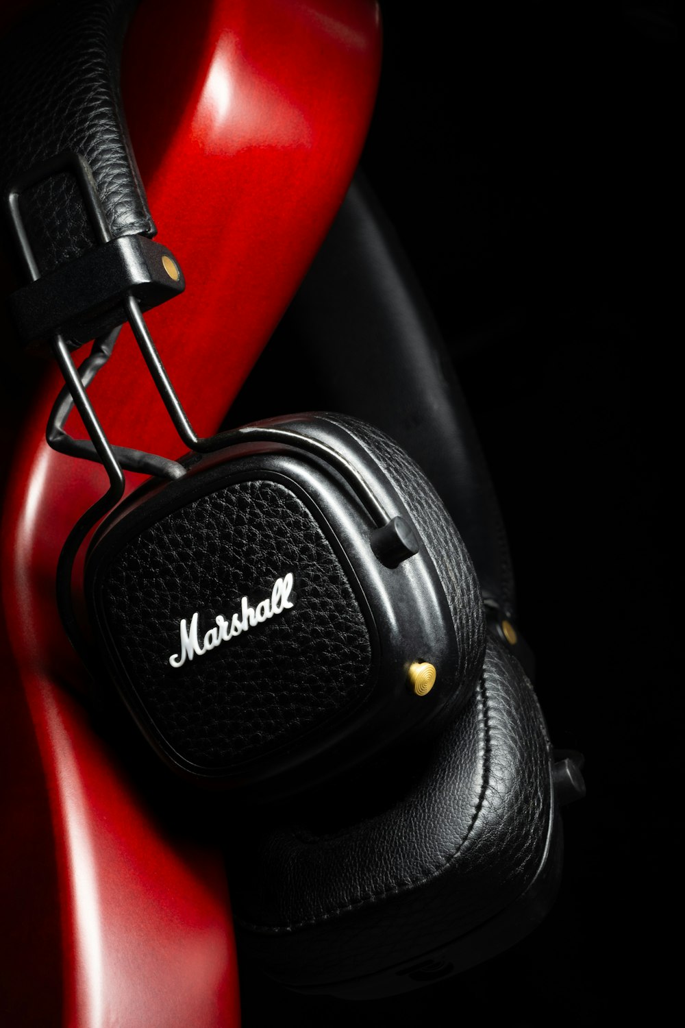 a pair of headphones sitting on top of a red chair