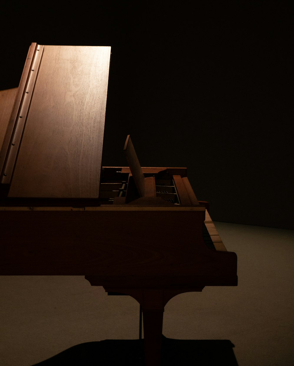 a piano sitting on top of a wooden table