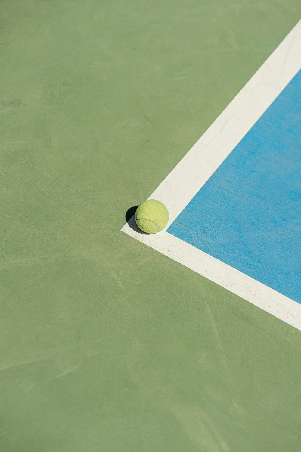 a tennis ball sitting on a tennis court