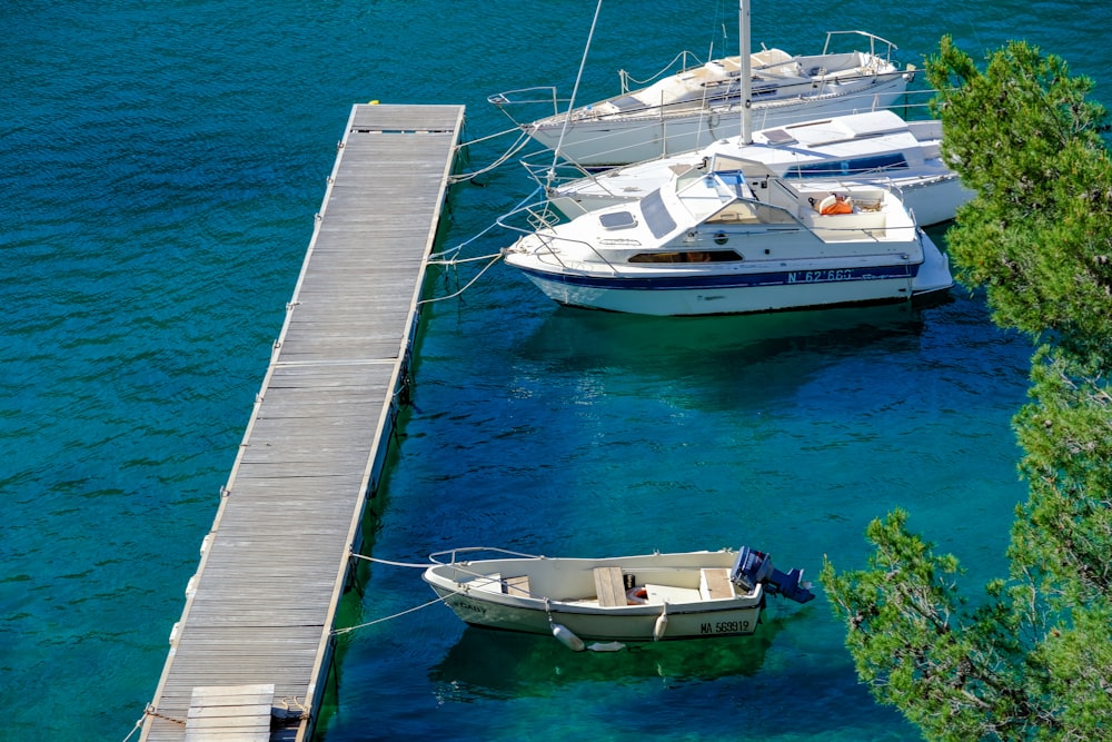 two boats are docked at a dock in the water