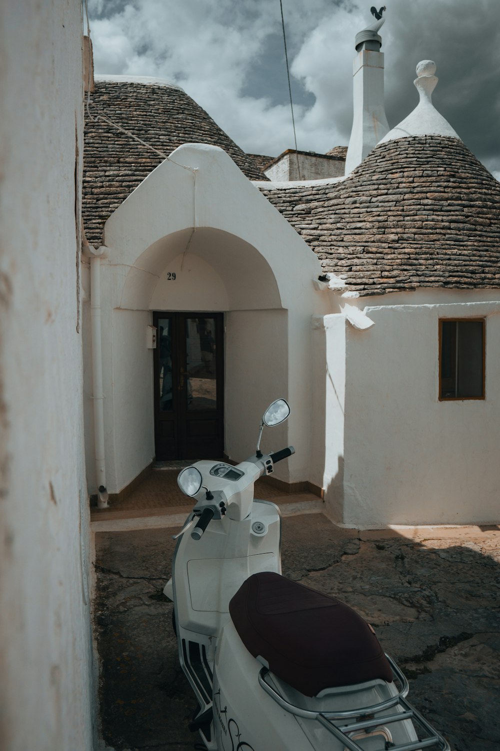 a motor scooter parked in front of a white building