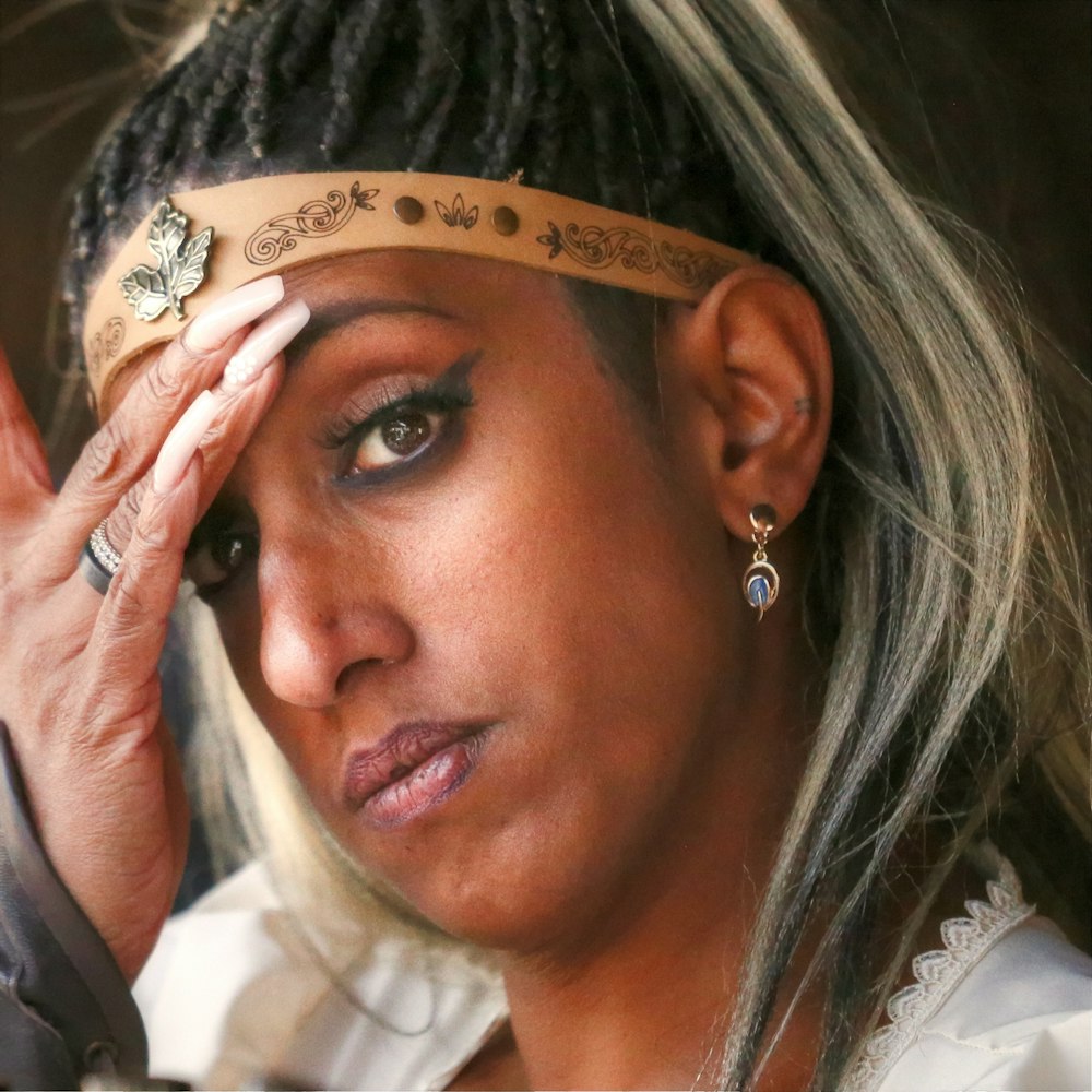 a woman holding her head with a band around her head