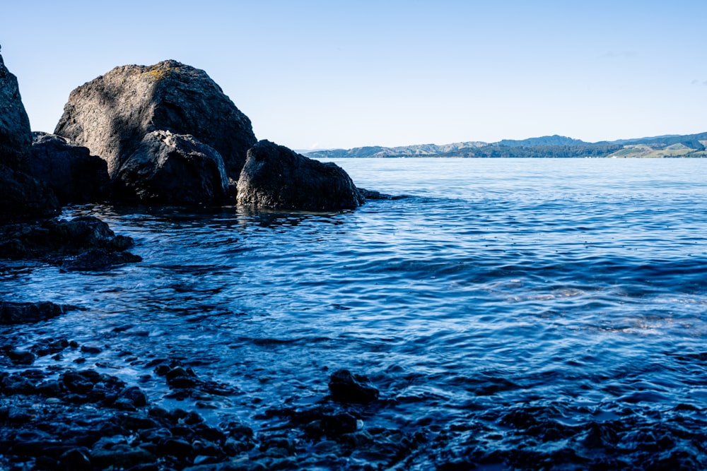 a body of water with rocks in the middle of it