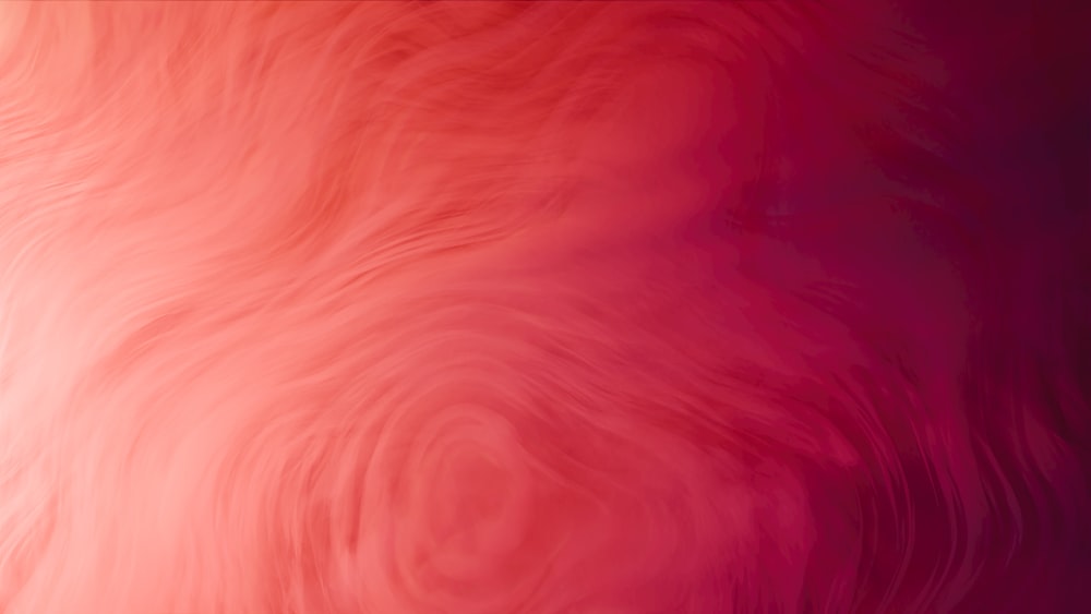 a blurry image of a red and pink background