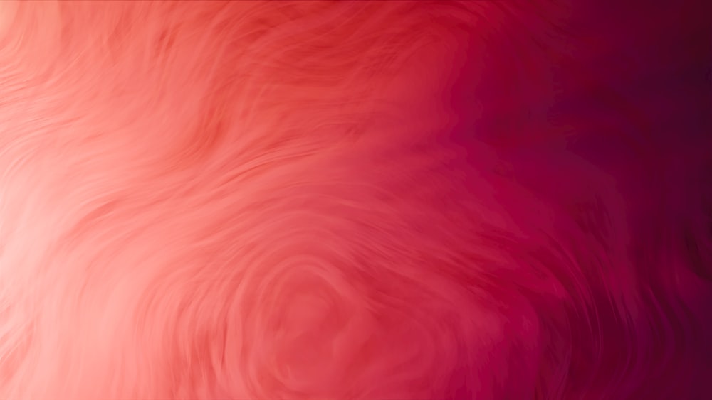 a blurry image of a red and pink background