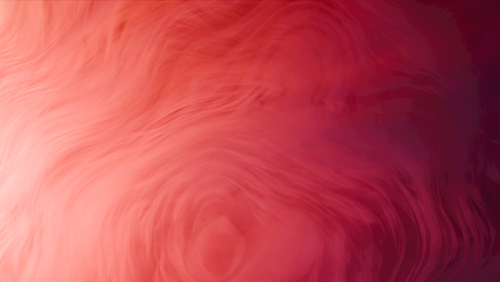 a blurry image of a red and pink background