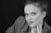 a black and white photo of a woman wearing a suit
