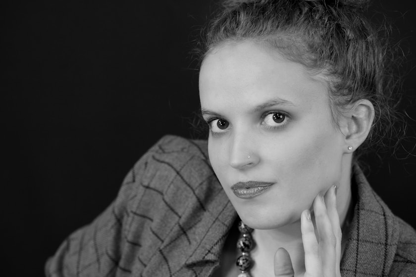 a black and white photo of a woman wearing a suit